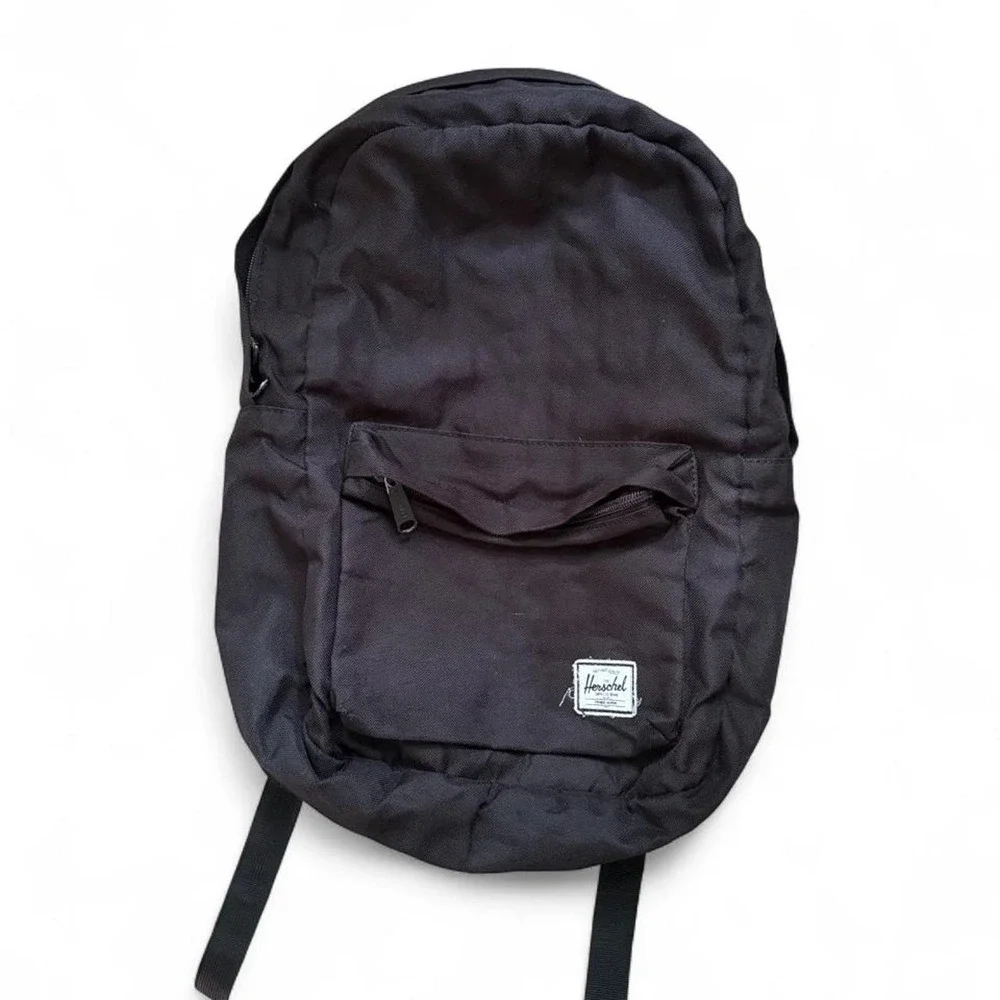 Herschel black backpack with red and white striped interior